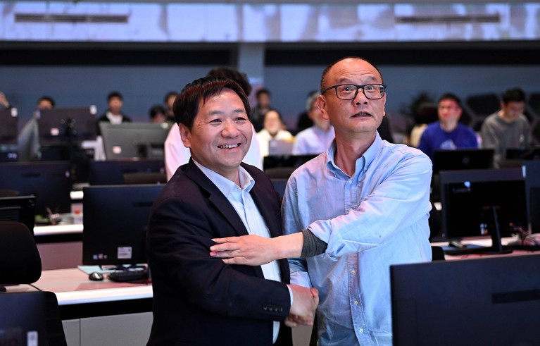 Gong Xianzu (right) and ASIPP director Song Yuntao shake hands after a successful experiment at the control center of EAST in Hefei, east China.