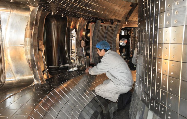 A man workers within the vacuum vessel of EAST.