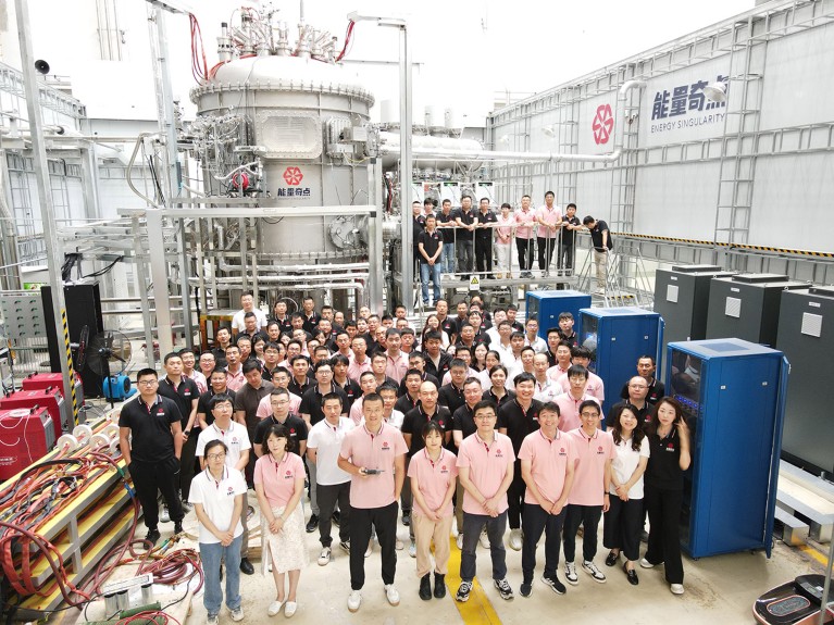 Group photo of Energy Singularity team with the HH70 tokamak.