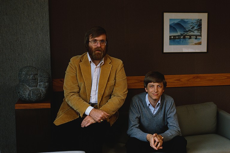 Paul Allen sits next to Bill Gates on a sofa