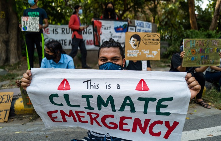 Participants display placards during a demonstration as a part of a climate emergency movement in New Delhi.