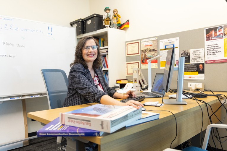 Portrait of Christiane Reves at her desk and working in her office