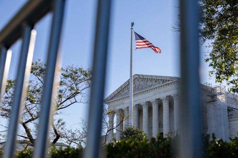 The Supreme Court of the United States is seen through fencing