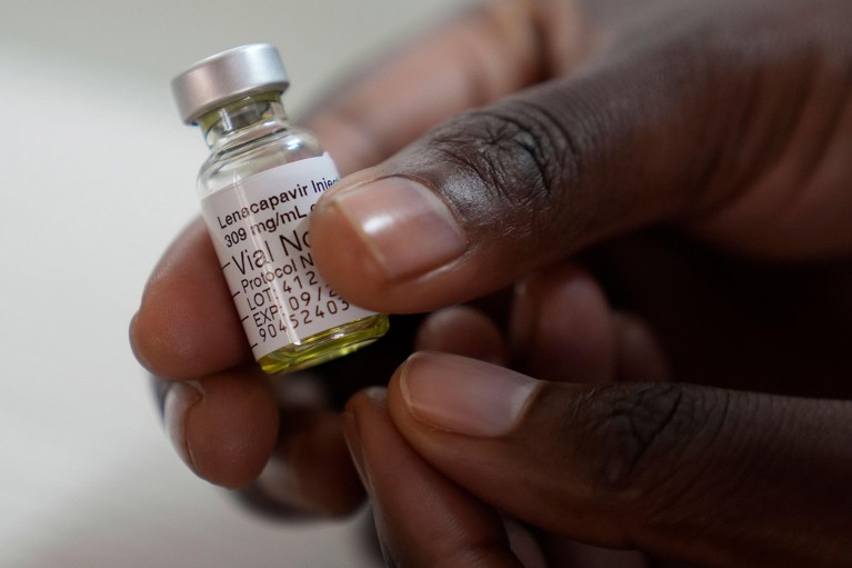 Close up view of a pharmacist hands holds a vial of lenacapavir.