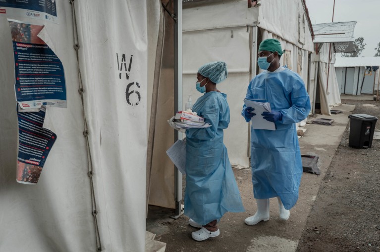 Two health workers wearing full PPE enter a ward at an Mpox treatment centre