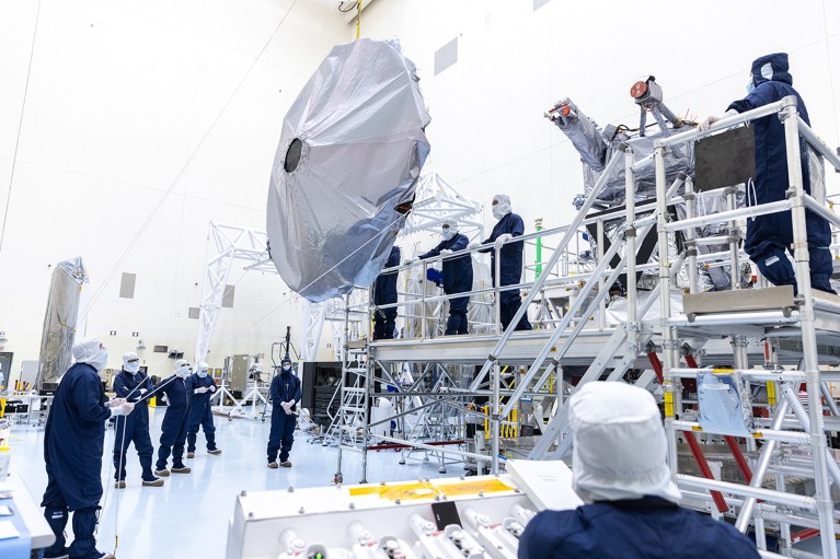 Technicians in a clean room prepare to install the nearly 10 feet (3 meters) wide dish-shaped high-gain antenna to NASA’s Europa Clipper.