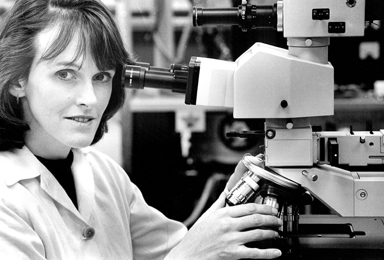 A black and white photograph of Cathy Foley at her Linfield Office in 1993