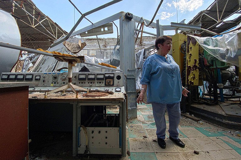 Galyna Tolstolutska stands in ruins of her department which was heavily damaged after a Russian attack in Kharkiv