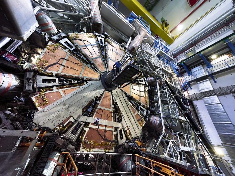 The 100 tonnes wheel is lowered 80 metres underground in the ATLAS cavern at the LHC level at CERN.