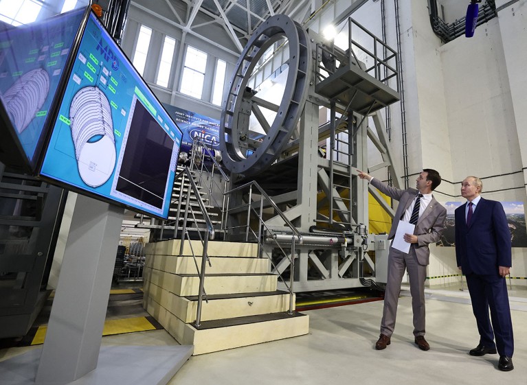 Russia's President Vladimir Putin examines the heavy-ion collider ring of the NICA (Nuclotron-based Ion Collider Faility) complex during a tour of the Joint Institute for Nuclear Research in Dubna.