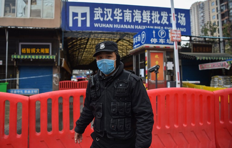 A police officer stands guard outside of Huanan Seafood Wholesale market where the coronavirus was detected in Wuhan on January 24, 2020.