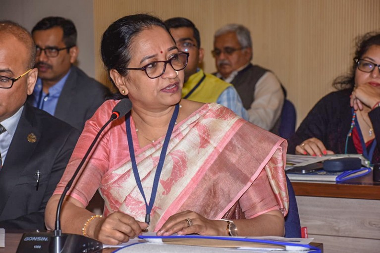 Indu Murthy talking into a microphone during a consultation meeting