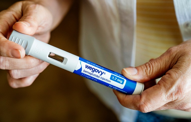 A woman holds a Wegovy injector pen in her Wenatchee, Wash., home, on June 3, 2024.