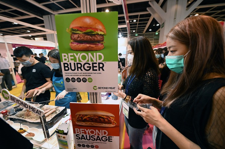 A visitor tries a plant-based meat substitute product at a food expo in Hong Kong.