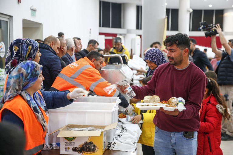 Meals are distributed to Turkish earthquake survivors being housed on passenger ship