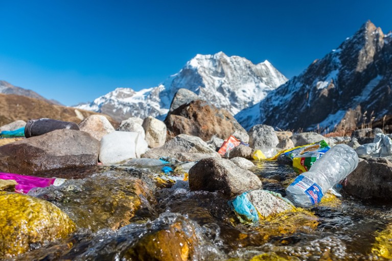 Close up of plastic bottles and other rubbish discarded a glacial stream in the Himalayan mountains, Nepal