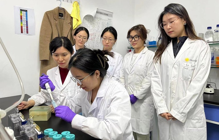 Researchers from the School of Life Sciences of Tianjin University conduct an experiment in a laboratory.