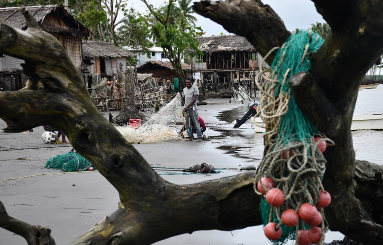 A fisherman untangles a gillnet at Veraibari village in the Kikori River delta, Papua New Guinea.