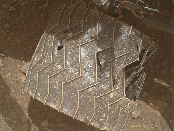 A view of the right-middle wheel of NASA's Mars rover Curiosity, one of the rover’s six well-travelled wheels.