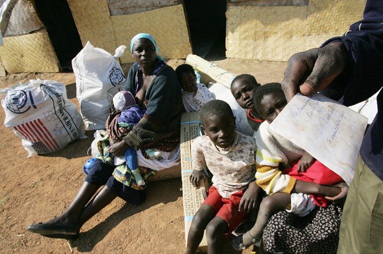 A woman and children from Angola, who spent years as refugees in neighbouring Zambia, wait to register at the Huambo returnees camp in 2005.