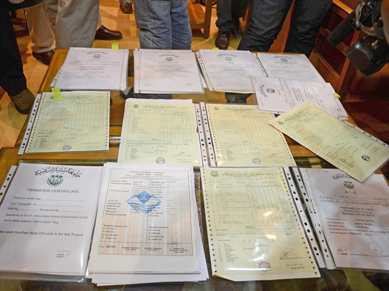 Fake degree certificates on a table recovered by the Delhi crime branch in New Delhi on Saturday.