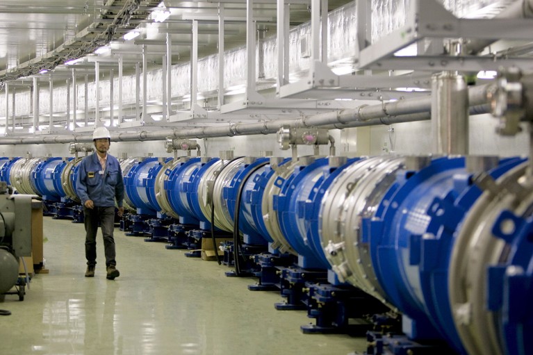 A worker walks along the Neutrino Beamline at the Neutrino Experimental Facility at the J-parc in Tokai Village in 2008.