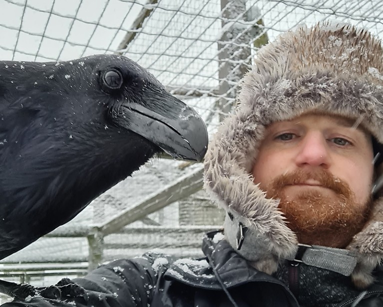 A photo of Ivo Jacobs holding a raven