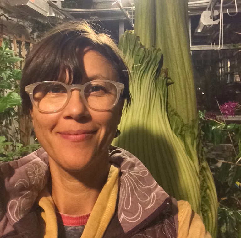 Jane Hill stands in front of a Corpse plant