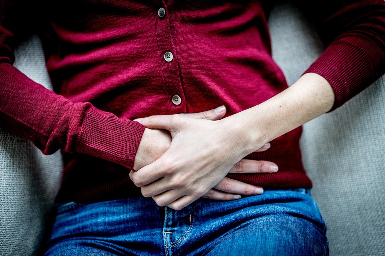 Woman suffering from abdominal pain.