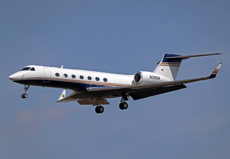 A Gulfstream G550 from a private company with its landing gear out