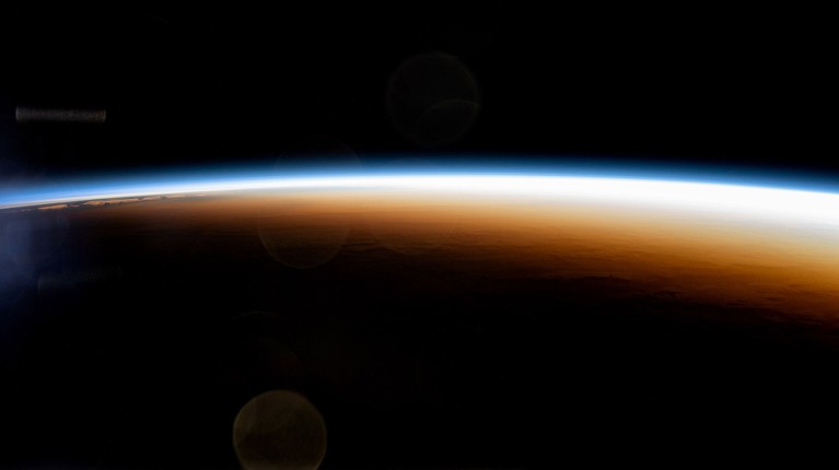 An orbital sunrise colorfully illuminates the Earth's atmosphere in this photograph from the International Space Station.