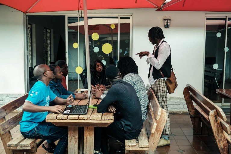 Dixon Chibanda, the founder and chief executive of Friendship Bench, speaks with some of his staff at his Harare offices in Zimbabwe.