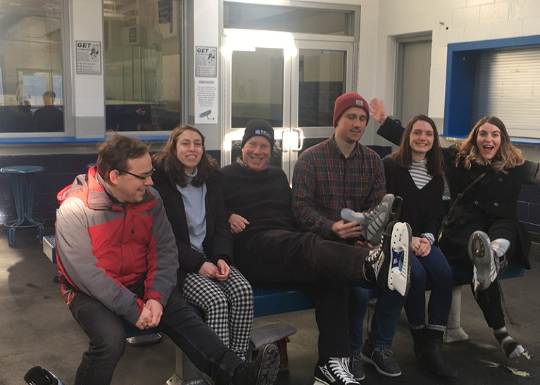 Charles and his team pose together on an ice skating outing