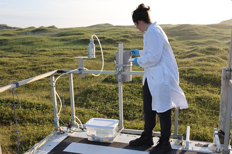 Justine Ammendolia is pictured in a white lab coat on Sable Island.