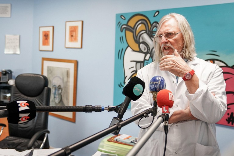 Didier Raoult pictured speaking into media microphones during a visit to IHU Mediterannee in France in 2020.