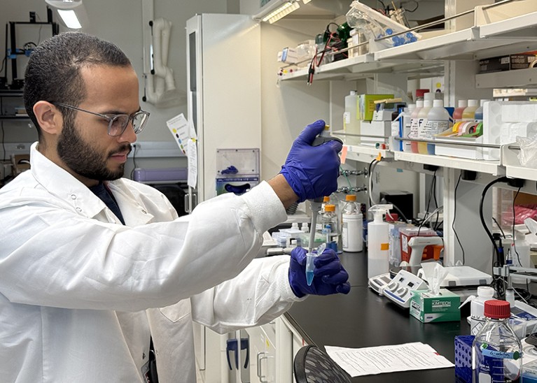 Ruben in the lab holding a pipette