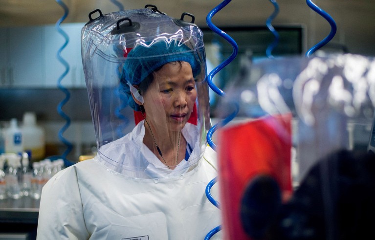 Shi Zhengli wearing protective clothing in a biosafety lab.