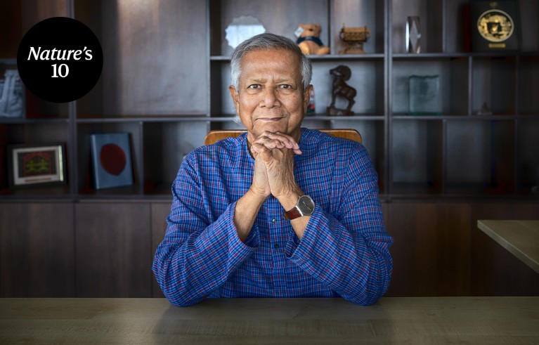 Portrait of Muhammad Yunus sitting at a desk in an office