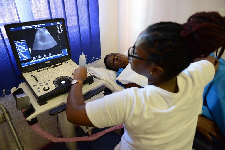 A radiographer performs an investigative kidney ultrasound on a patient.