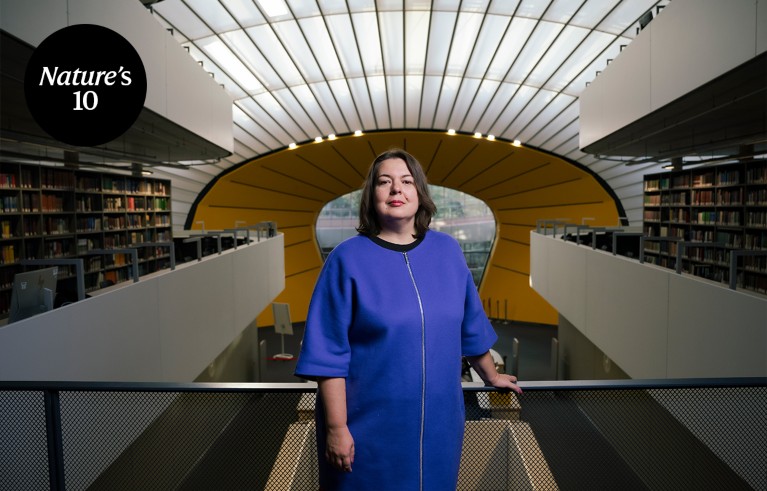 Portrait of Anna Abalkina standing in an atrium in a university library