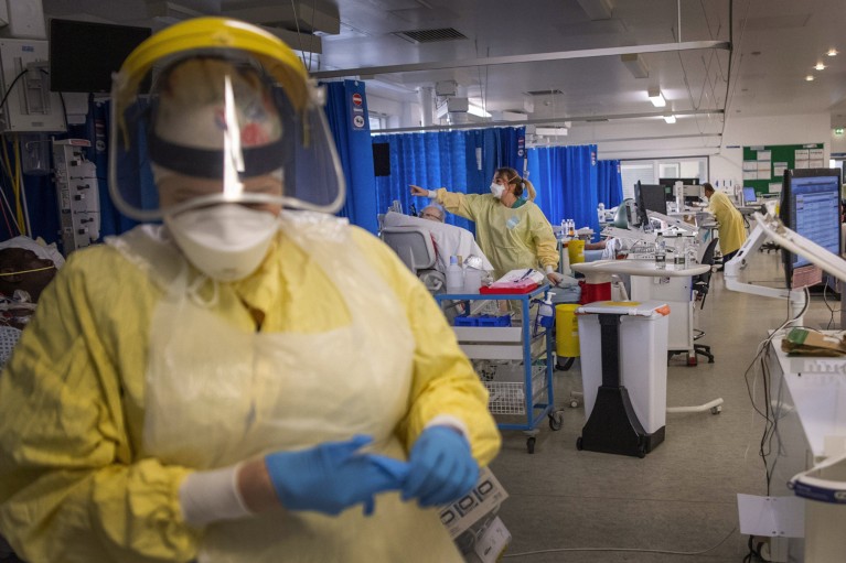 Nurses wearing PPE while working in an intensive care unit