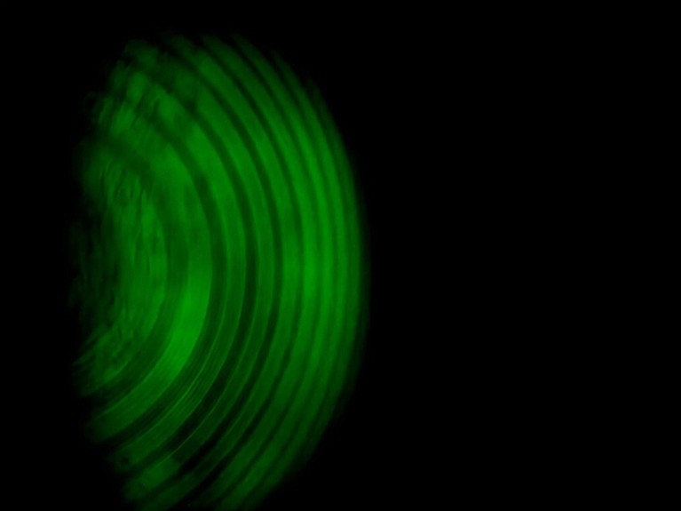 A concept image showing the Zeeman effect in green on a black background