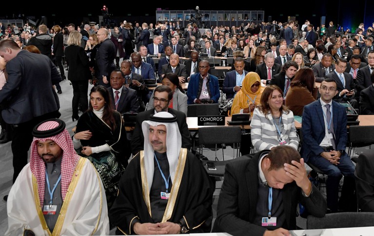 General view of people from around the globe, sitting and listening to speeches.