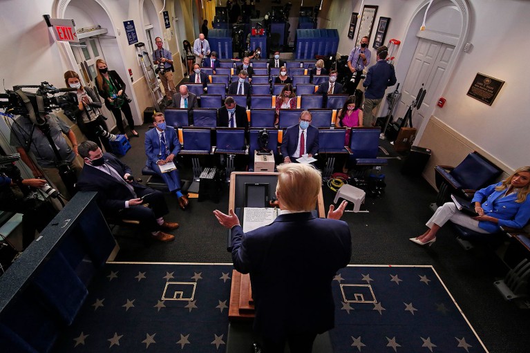 A view from behind then U.S. President Donald Trump as he talks to journalists during a news conference about the ongoing global coronavirus pandemic in July 2020.