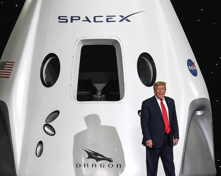 Donald Trump takes the stage besides a SpaceX Dragon module at NASA's Vehicle Assembly Building in Cape Canaveral, Florida in 2020.