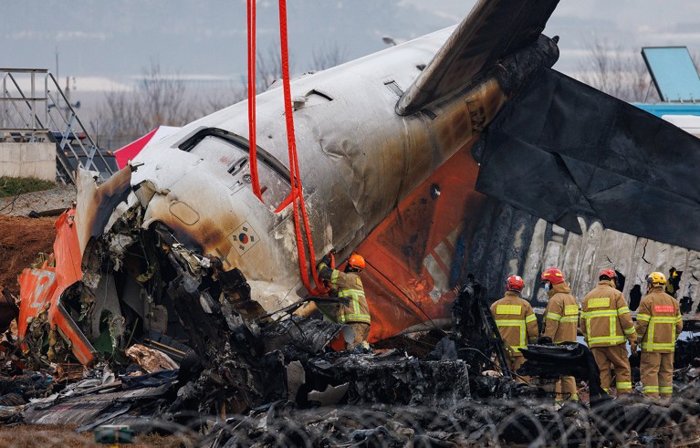 Firefighters inspect the wreckage of Jeju Air Co. Flight 2216 at Muan International Airport in Muan County, South Korea