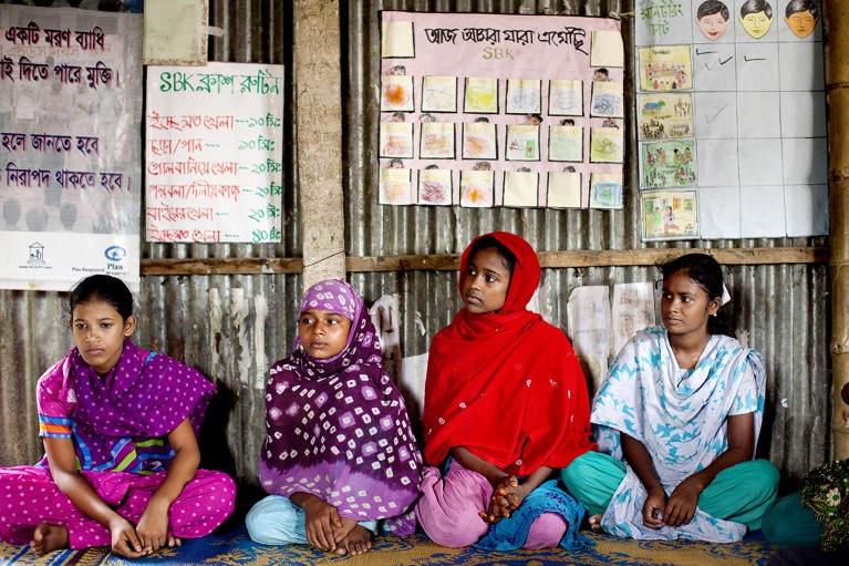 Young girls sit in a group at a monthly meeting run by children for children with the facilitation of partner NGOs to protect vulnerable children in Bangladesh.