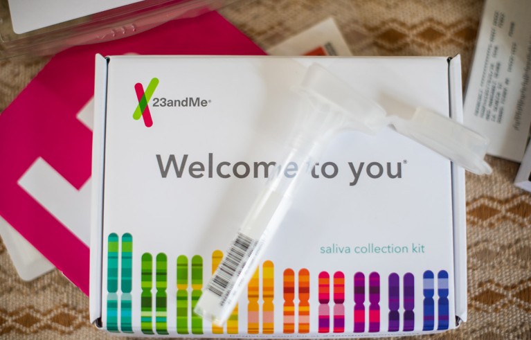 The arranged contents of a 23andMe Ancestry + Traits Service DNA kit.