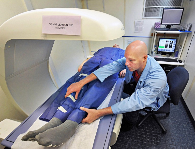 National CDC health technician Steve Trumore, at right, preps a test subject for a Dexa Scan in their mobile examination center as they prepare to assess Saratoga County residents on health and nutrition in Malta, NY in 2013.