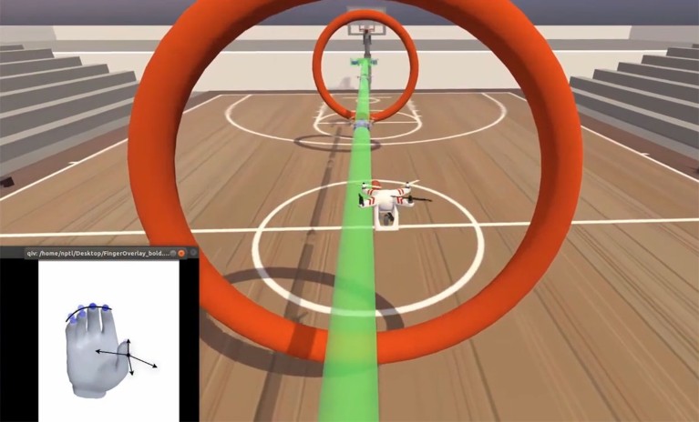 A still frame from a video showing finger iBCI control of a virtual quadcopter through an obstacle course